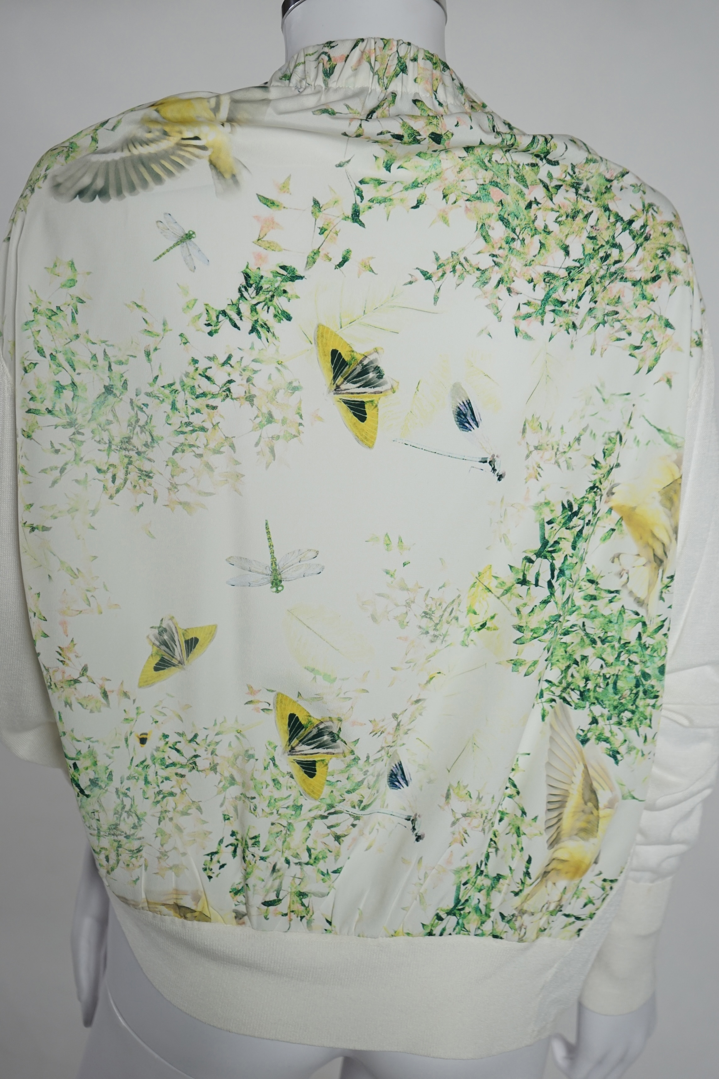 A lady's Angela Caputi silk cream skirt and blouse with fruit design size 46, a Ted Baker white lightweight cardigan with leaf design to the back size 4, a Rawhide dusky pink long laser cut coat size 14 and a Georgina vo